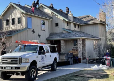 Workers installing a new roof on a residential house.