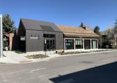 Chase bank branch located on a sunny street corner with clear blue skies.